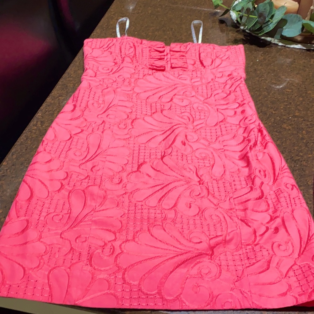 Coral strapless lilly. Lined and has boning.  EUC!